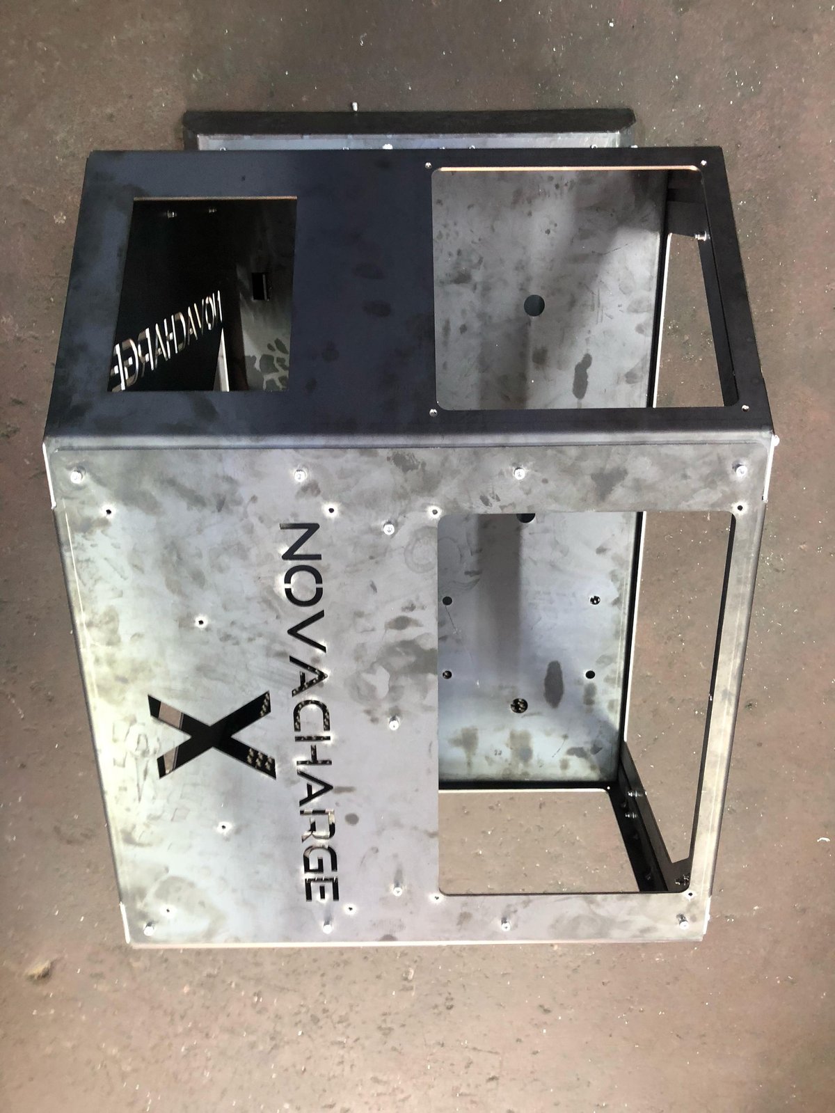 Nonchallenge branded metal box enclosure with black frame and weathered silver finish, multiple access panels and mounting holes