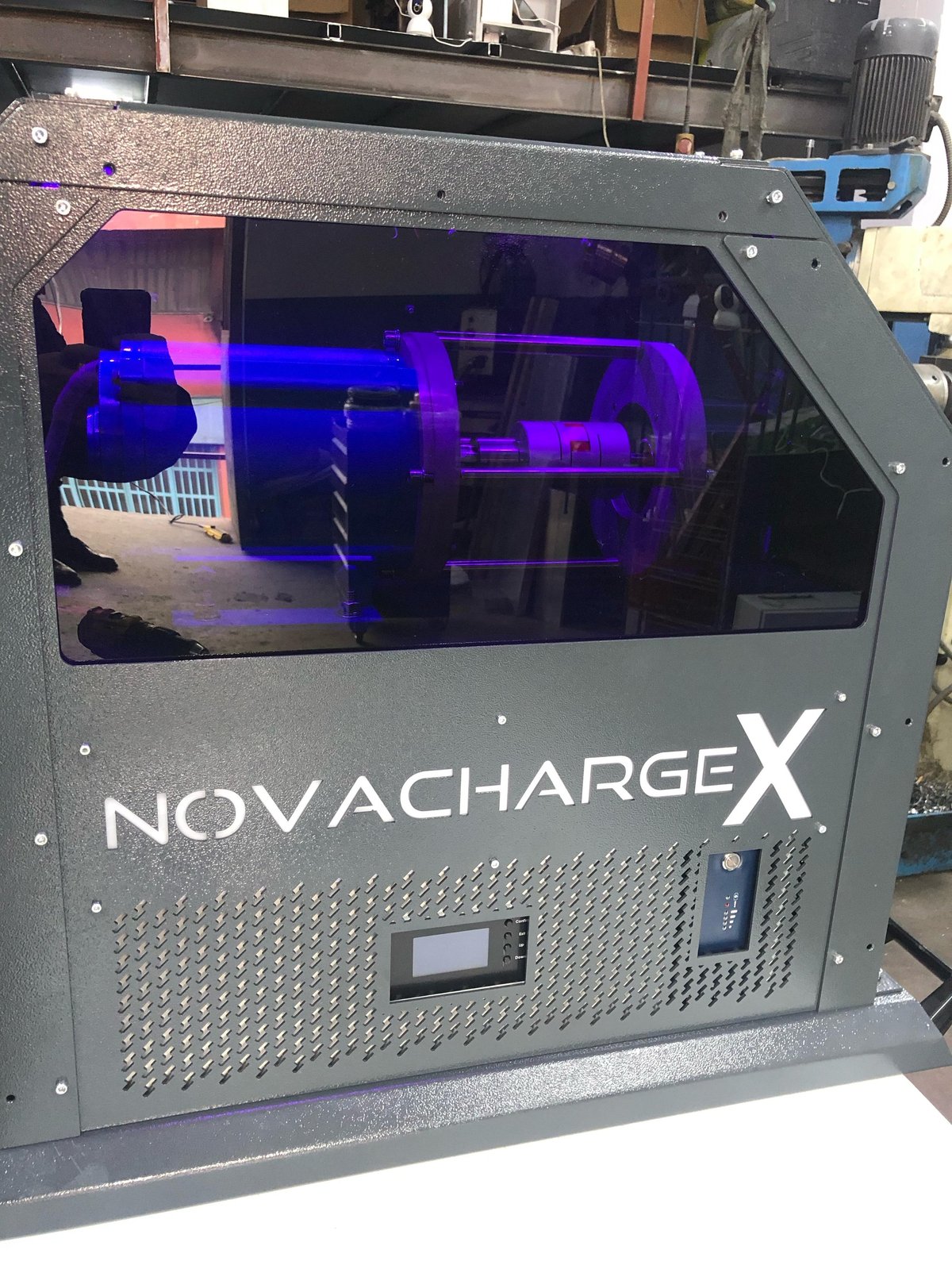 NovaChargeX industrial 3D printer with purple-lit printing chamber visible through front window
